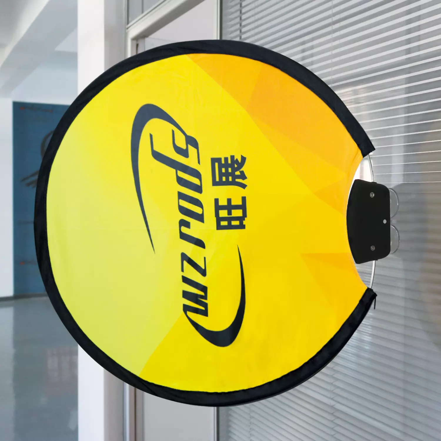 Round yellow WZRODS/旺展 sign attached to a window with black suction cup. Reflective glass background shows indoor lighting, perfect for retail or promotional displays.
