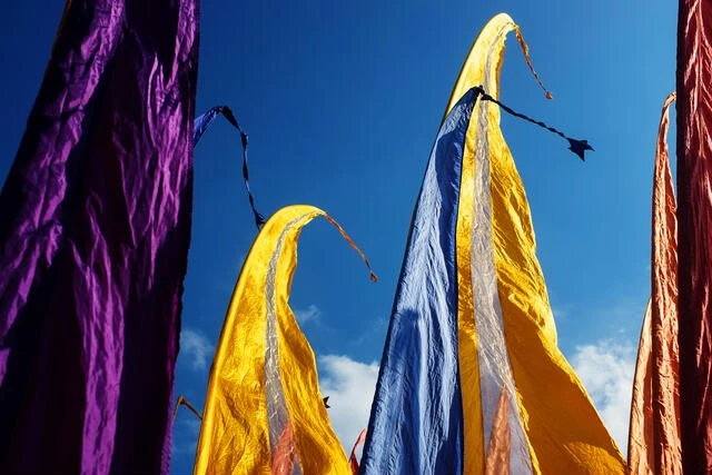 Traditional Balinese prayer flags with silver stripes in the wind Traditional Balinese flags with silver stripes fluttering in wind for ceremonies.