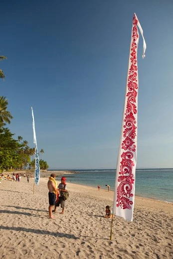 White and blue Bali banners on tropical beach for resort decor White and blue Bali banners on tropical beach, ideal for resort decor and promotions.