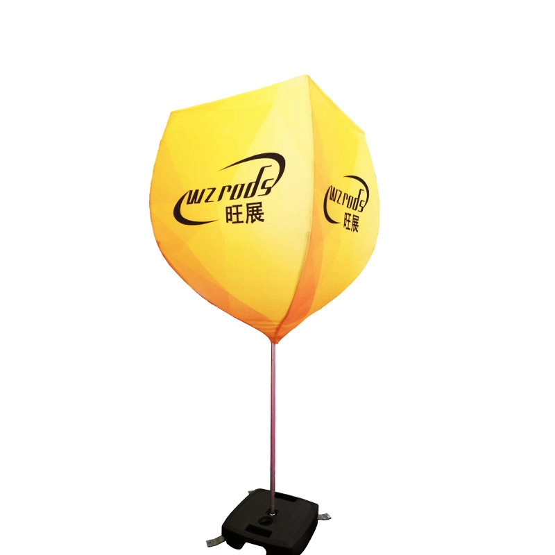 Burgundy Banner with stabilized concrete base, featuring yellow-orange gradient inflatable panel and black square footing for outdoor wind resistance.