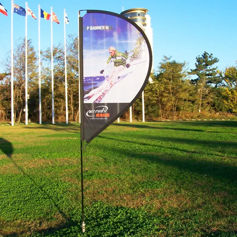 P BANNER M ski-themed display in action: Crescent-shaped flag mounted on black pole features dynamic skier graphic