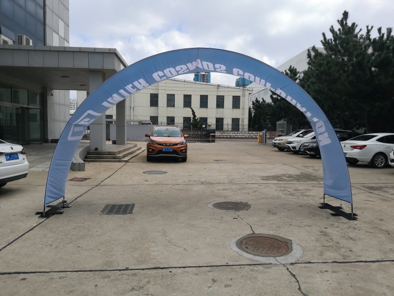 Blue single-sided arch banner stand with company logo and website printed on fabric, used as entrance gate