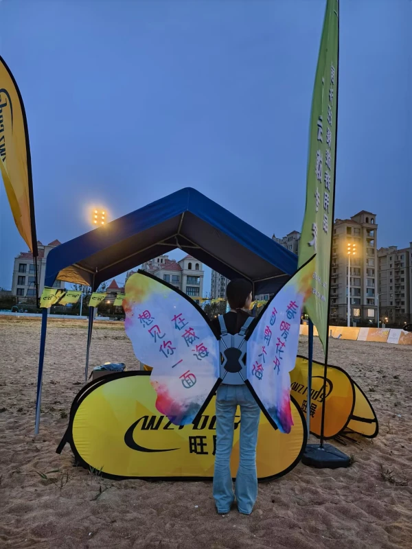 Outdoor advertising with pop-up banner, feather flags and butterfly-wing backpack banner