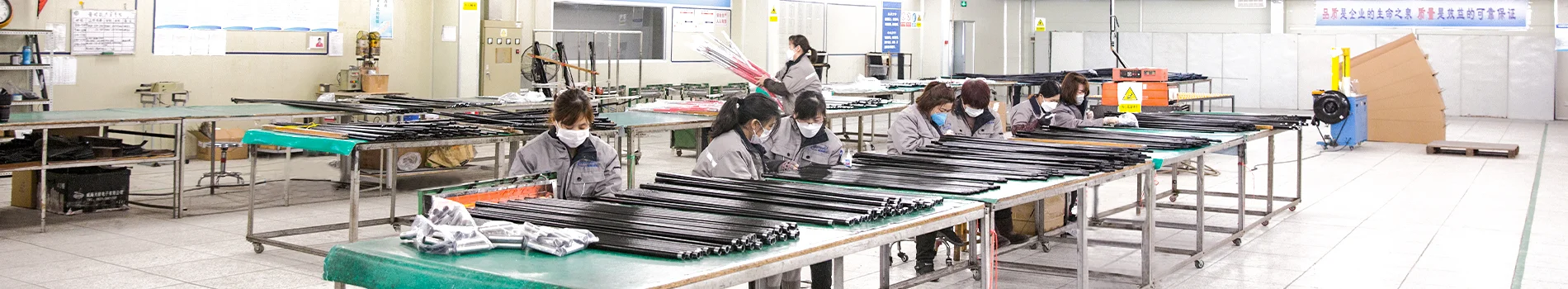 WZRODS factory: workers manufacturing advertising flag poles, showing quality production of blade & teardrop flags