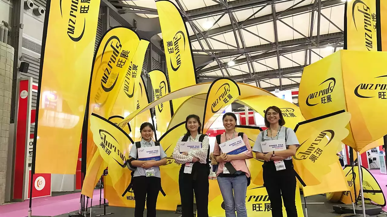 wzrods team at Wangzhan trade show booth, holding show materials