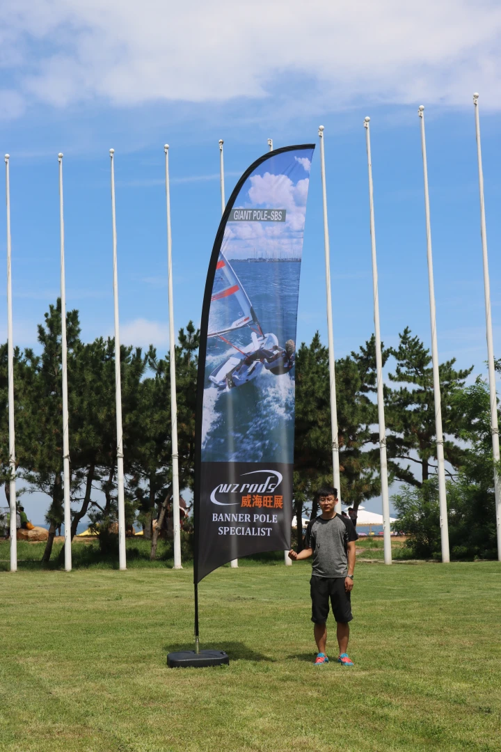 Black razor flag with sail graphic on pole, WZ RODS banner pole specialist outdoor advertising.