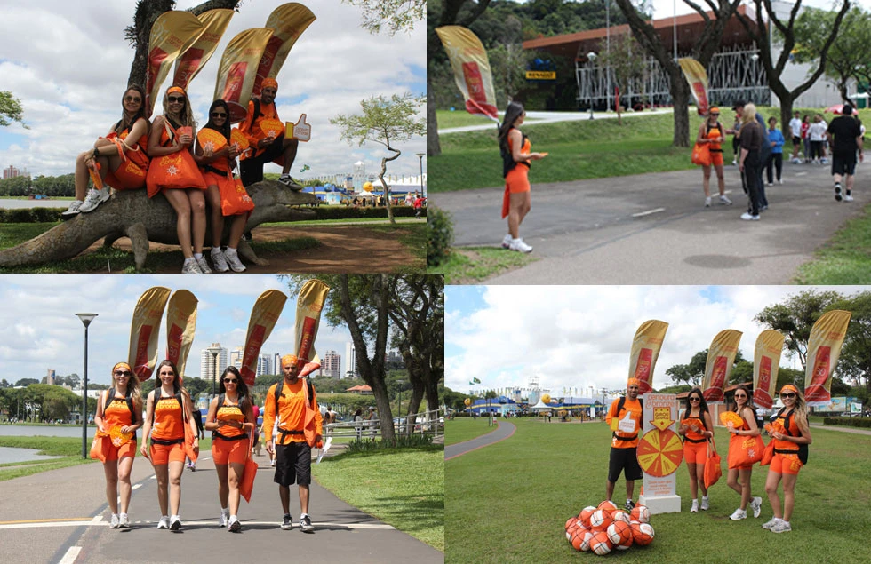 Orange-branded team with WZRODS flags for heating systems promotion in park activation campaigns