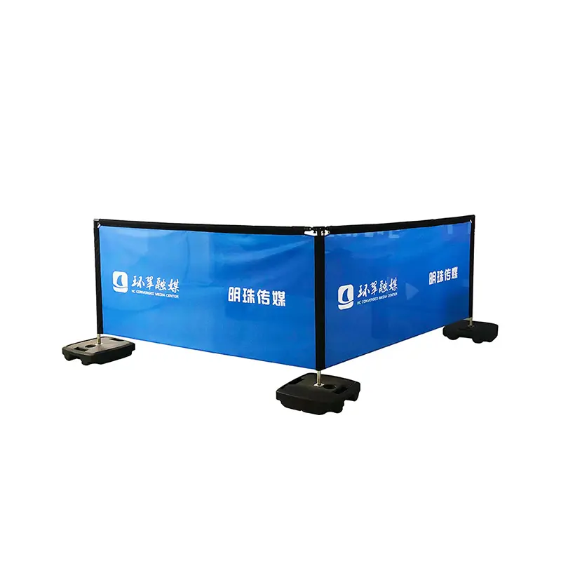 BS1000 modular barrier system with royal blue panels displaying HuanCui Media and MingZhu Media logos - L-shaped configuration with black stabilizer base for indoor/outdoor brand visibility