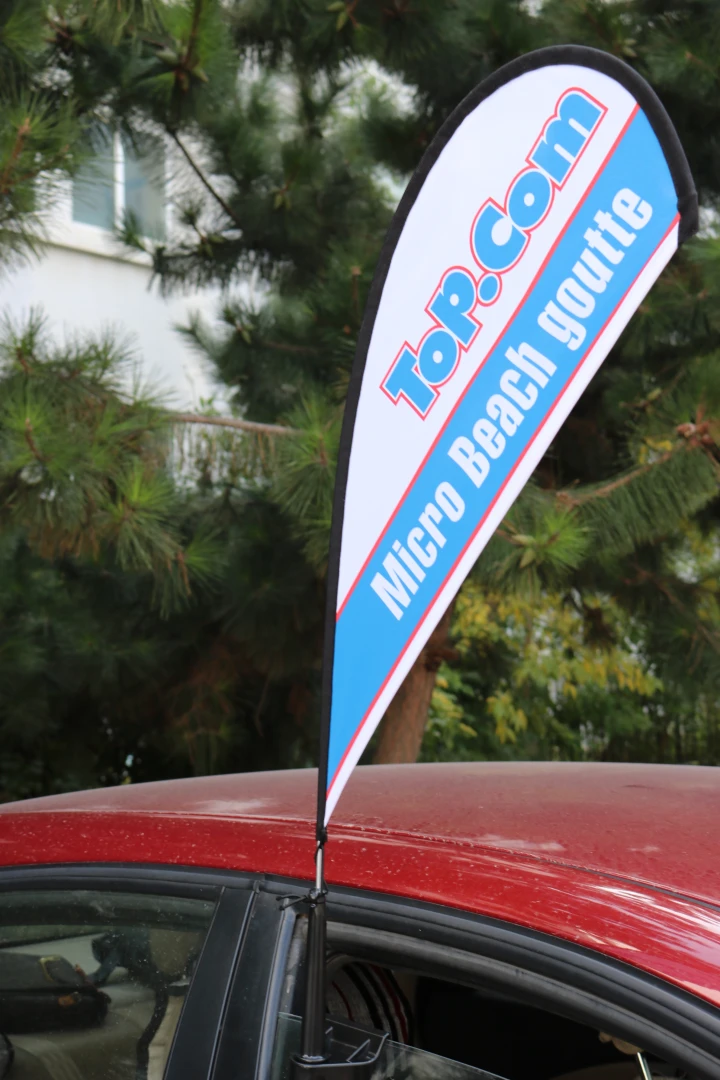 Car window flag with carbon fiber flagpole gallery 13 Black car window flag mount with a strap, attached to a red vehicle.
