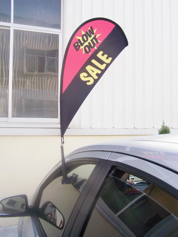Car window flag with carbon fiber flagpole gallery 21 Pink and black car window flag promoting a 'BLOW OUT SALE.'
