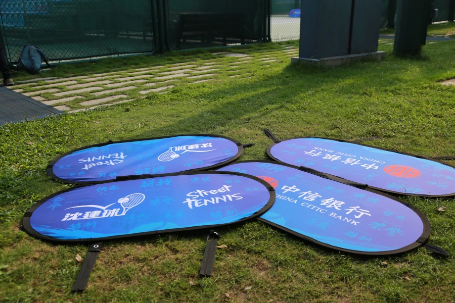 Pop up A Frame Banners Blue sideline banners ('Street Tennis,' China Citic Bank) lying on grass, prepared for installation at a sports event.