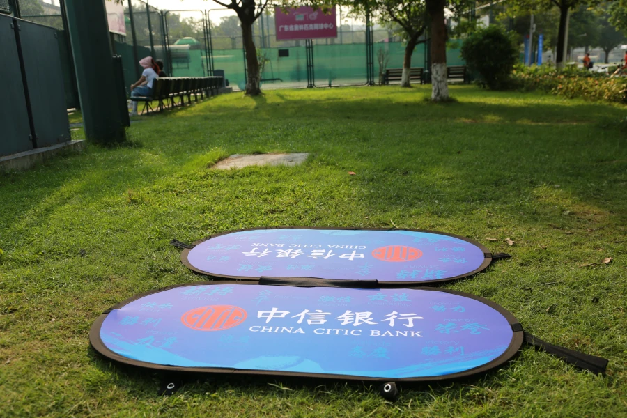 Pop up A Frame Banners Blue China Citic Bank sideline banner on grass, highlighting brand presence at a sports venue.