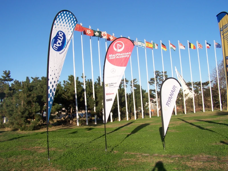 Foreground teardrop flags (Movo, MacPherson Golf, Ryanair) with international flags background