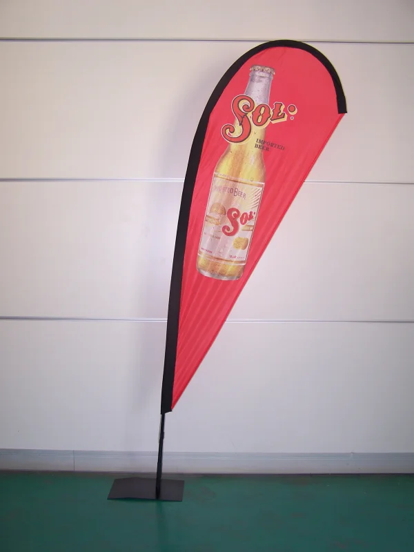 Red teardrop banner featuring Sol imported beer bottle with bold white and yellow branding
