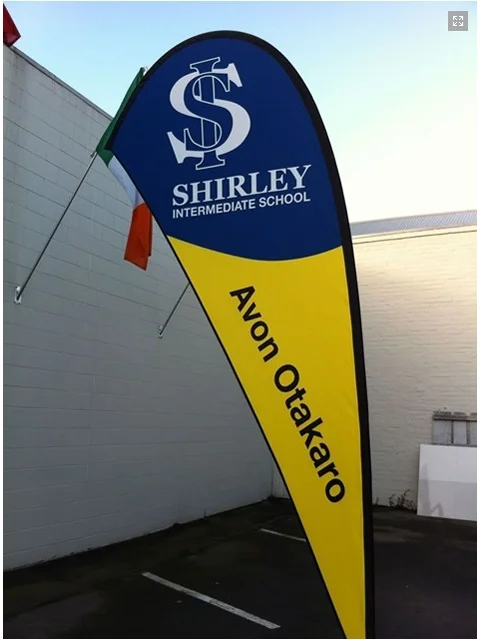 Blue/yellow teardrop banner for Shirley Intermediate School with 'Avon Otakaro' branding
